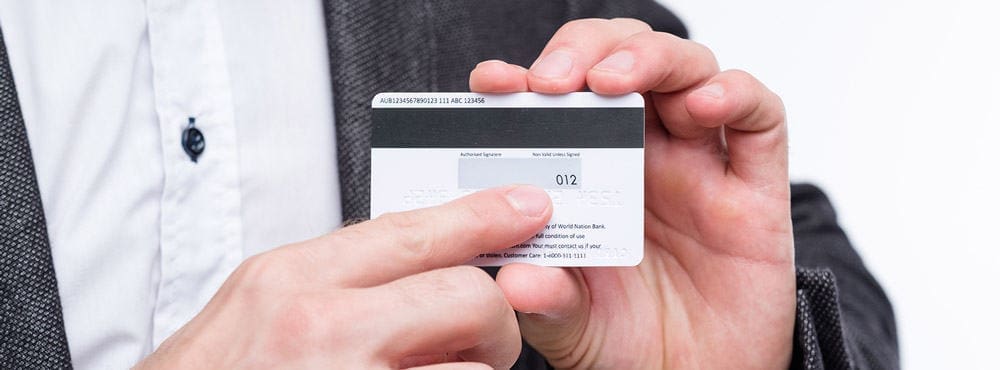 Article Head Image Template 2 1 man showing where CVV is located on a credit card