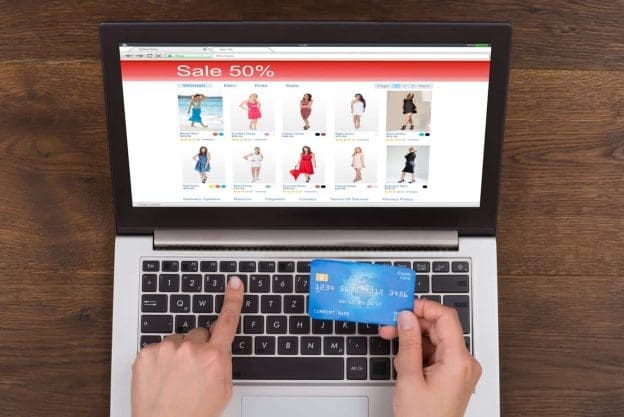person shopping online with credit card and laptop 58561540