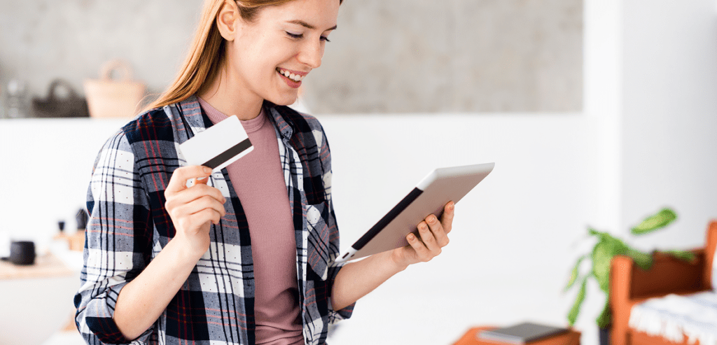 medium shot woman holding her credit card looking tablet 1 medium shot woman holding her credit card looking tablet 1
