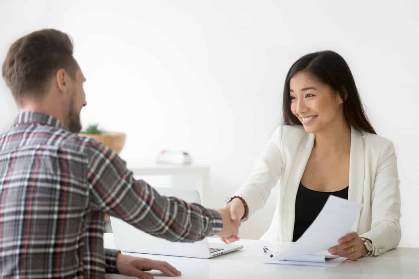 smiling asian businesswoman handshaking businessman hiring or si 116517330 1 1 customer relationship
