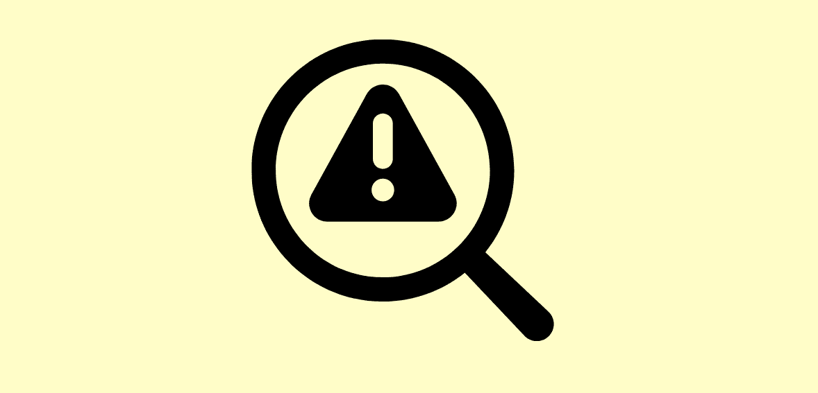 Warning symbol magnified with magnifying glass, caution alert icon.