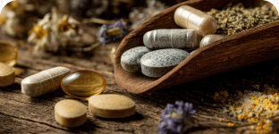 Supplements and vitamins on a rustic wooden surface for health and wellness.