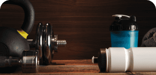 Kettlebell, dumbbell, water bottle, and gym accessories for fitness training and workout routines.