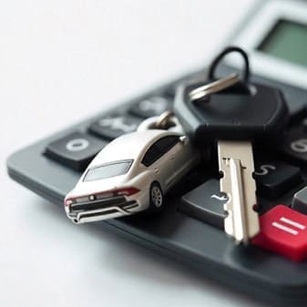 Car key and remote on calculator for secure payment processing.