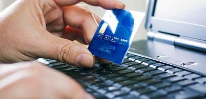 Secure card payment using a blue chip on a laptop keyboard.
