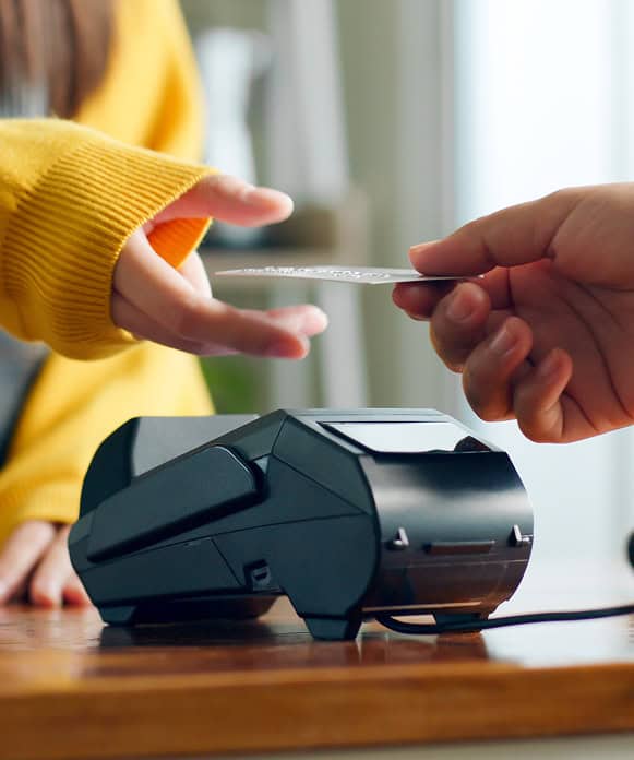 Contactless card payment being processed on a modern POS terminal.