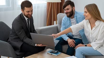 Business meeting with laptop and financial discussion, modern office environment.