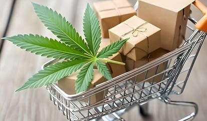 Cannabis leaf with shopping cart and delivery boxes, online cannabis purchasing, eco-friendly packaging.