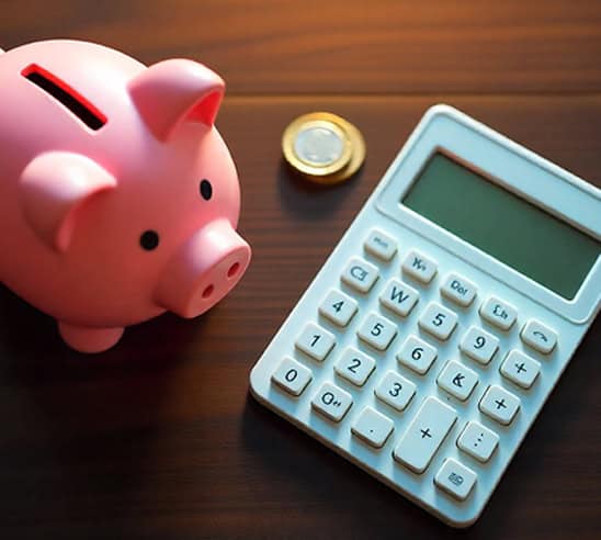 Piggy bank, calculator, and coin on wooden surface representing financial savings and payment processing.