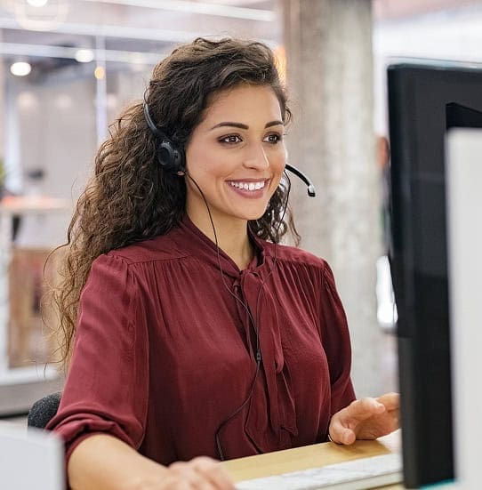 Customer service representative with headset at call center for merchant services and payment processing solutions.