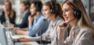 Efficient customer service team with headsets assisting clients in a call center.