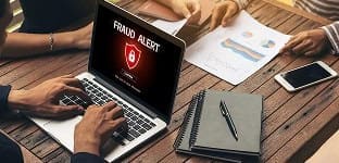 Virus alert on laptop screen warning about cybersecurity threats.
