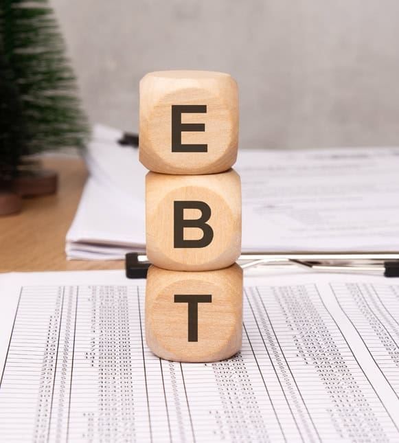 Clear BET letters on wooden blocks representing business finance and payment processing.