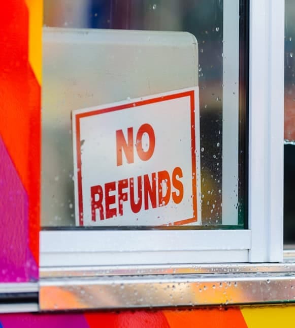 No refunds sign on a glass door or window.