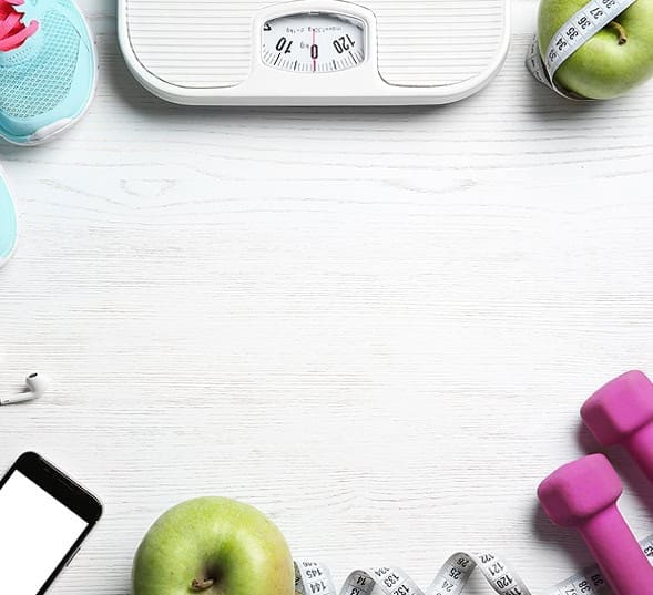 Smartphone with weight scale, apples, and fitness accessories on white background for health and weight management.