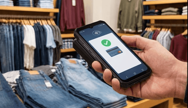 Contactless payment transaction on smartphone in clothing store,