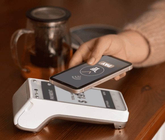 Contactless payment terminal with smartphone, card reader for secure credit card transactions.