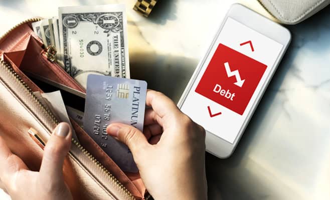 Debt management financial crisis on smartphone screen with cash and credit cards in purse.