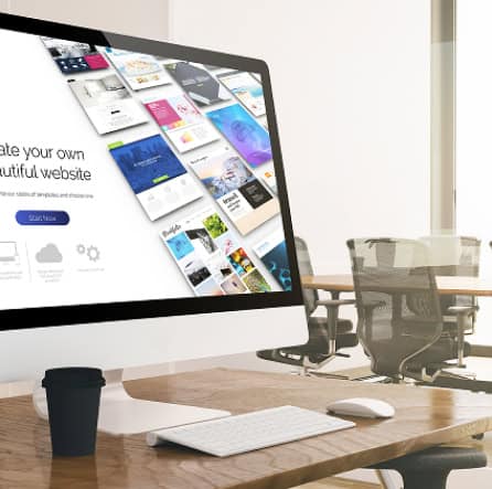 Creative website design on a computer screen for digital marketing and online business solutions.