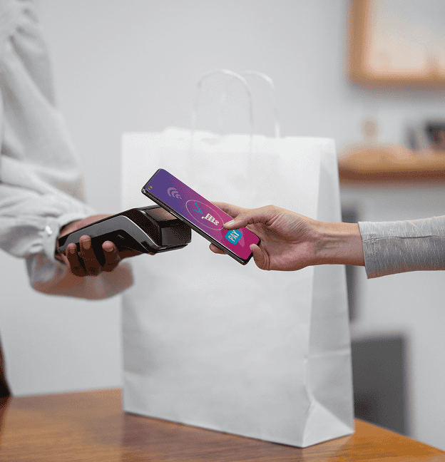 Contactless payment transaction at a retail store with mobile phone and card reader.