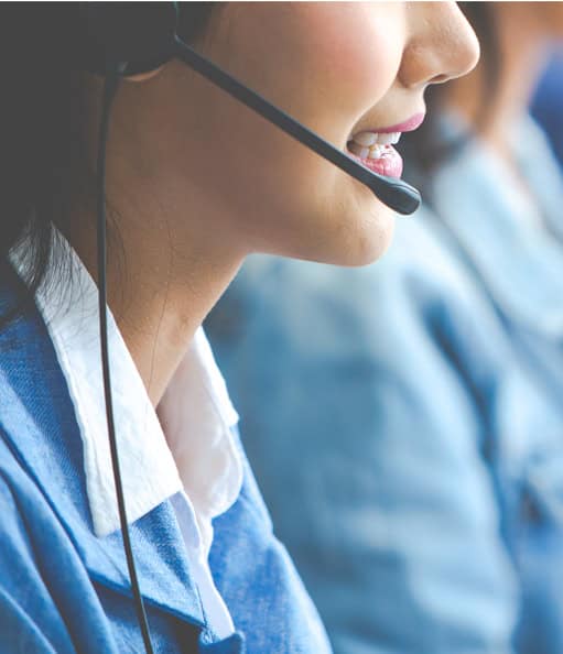 Efficient customer service representatives with headsets at Host Merchant Services call center.