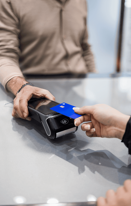 Contactless credit card payment with POS terminal at checkout.