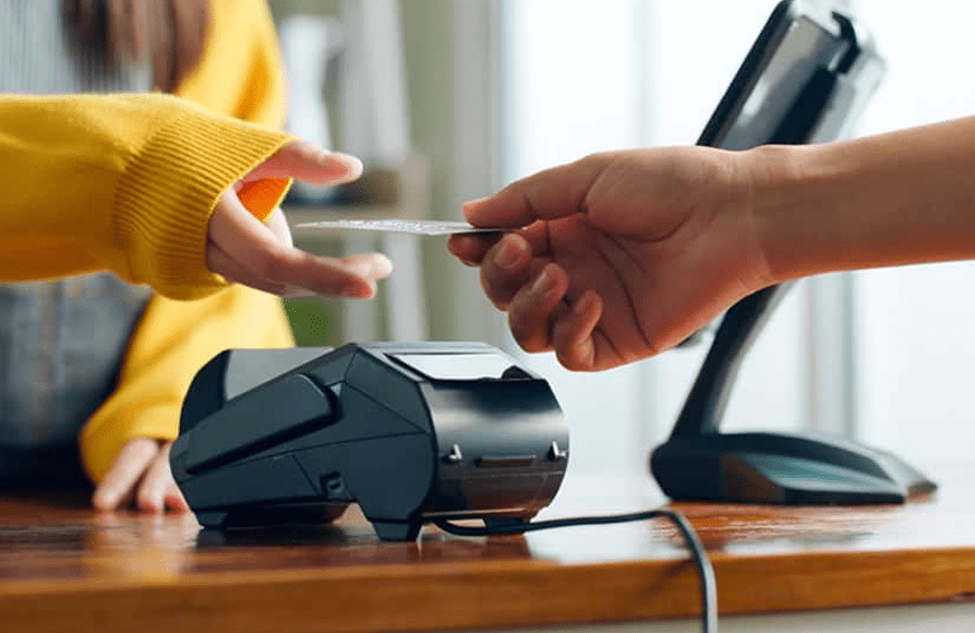 Contactless payment terminal accepting card from customer, POS device, payment processing.