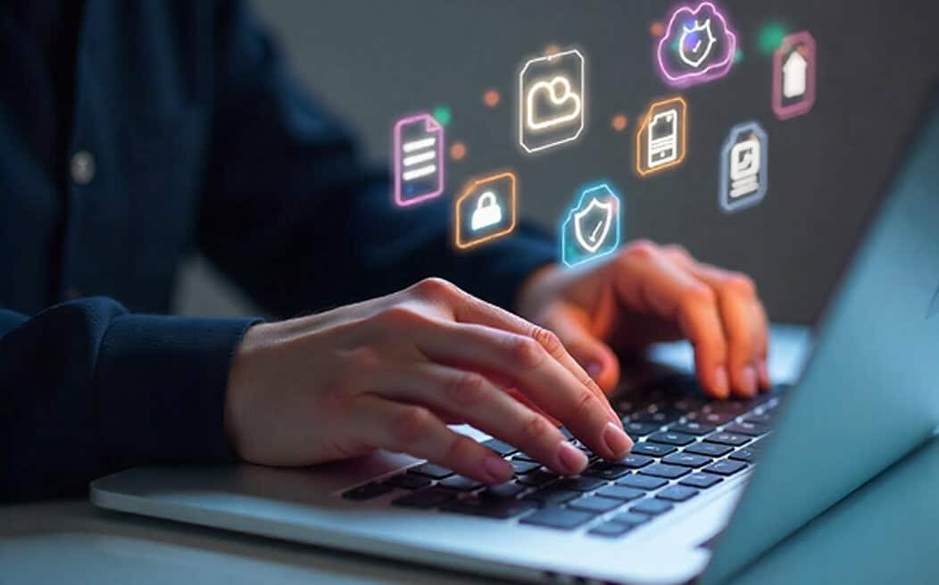 Secure payment technology icons on laptop with person typing, illustrating Host Merchant Services solutions for online transactions.