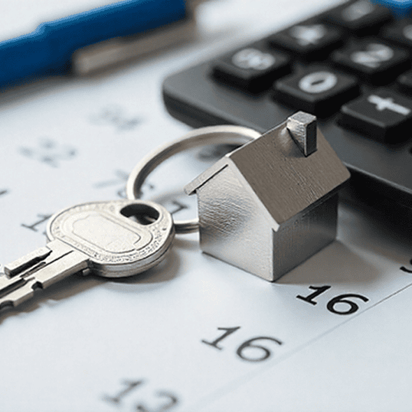Secure house key with miniature house and calculator for mortgage or real estate concept.