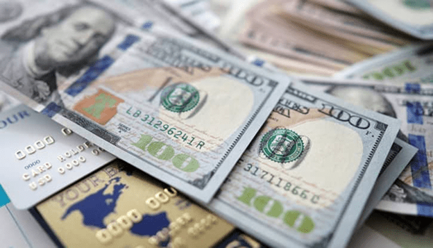 $100 bills and credit cards representing payment processing and merchant services solutions.